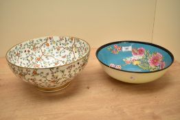A Royal Doulton bowl decorated in the Japanese taste having hand painted floral patterns on a blue