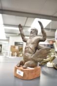 A mythical sea creature having hands raised, mounted on a wooden base, h24cm