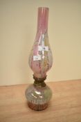 A 20th century oil lamp having iridescent style glass, h38cm