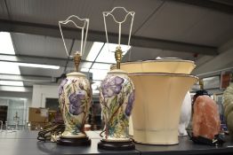 A pair of Moorcroft pottery table lamps of lobed form having tube line floral decoration and
