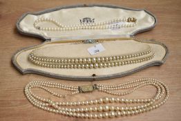 Three sets of faux pearl necklaces, comprising a single row having a silver clasp, a double row, and