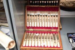 Two early 20th Century cased fish knife and fork sets, including Walker & Hall