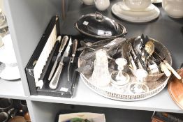 A quantity of silver plated cutlery, to include a pair of candlesticks, a lidded tureen, and a sugar