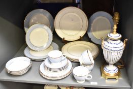 A Doulton dinner service, having gilt edge on a blue and white ground, to include plates, cups and