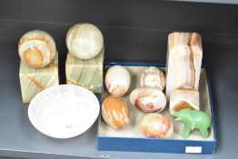 A pair of onyx bookends of spherical form, h14cm, sold together with a bowl and eggs ect, (11)