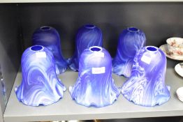 A set of 6 blue glass shades having ruffled edges, h12cm