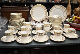 A 20th Century bone china part dinner service having gilt heightened design, stamped to base