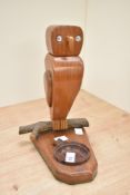 A 20th century wooden owl figure perched on a branch, h25cm