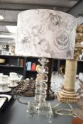 A modern glass illusionary style table lamp , having foliate glittered lamp shade