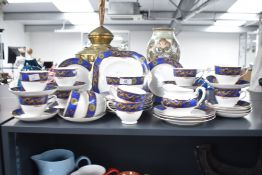 A Grafton China tea service decorated with dragon motifs, comprising of 12 cups, 12 saucers, 13