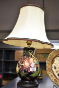 A Moorcroft Pottery 'Queens Choice' pattern table lamp, of baluster form tube-lined with foliate
