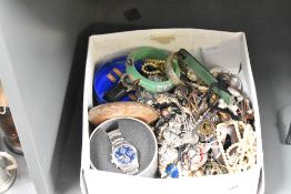 A large assortment of costume jewellery, including boxed Looney Tunes and Fosters wristwatches, faux