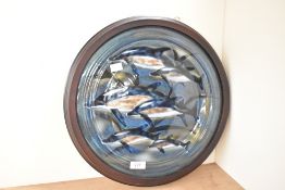 A Cobridge Pottery circular ceramic wall plaque decorated with dolphins and dated 2002, impressed
