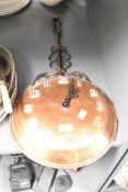 A 20th century copper bed pan converted into a wall clock, L64cm