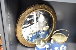 A vintage brass framed porthole type convex mirror 37cm