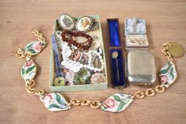 An assortment of costume jewellery, including a silver tie clip, an amber chip bracelet, faux pearls