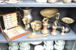 A black vintage weighting scale with brass weights, sold together with a canteen of cutlery, a