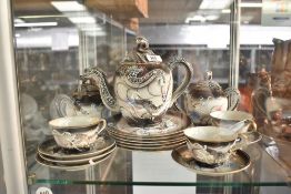A Chinese tea service decorated with dragons, to include tea pot, cups and saucers ect, (17)