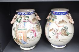 A pair of early 20th century 'Famille Rose' Chinese vases of baluster form, depicting scene of