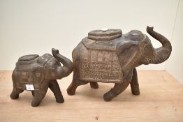An Indian elephant figure having trunk up and decoration with foliage patterns, h25cm, sold together