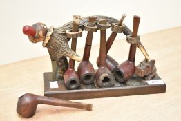 A novelty pipe rack, formed from an antler with antler section divisions, and carved Scottish