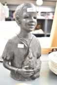A table top sculpture of an African boy with chicken, h33.5cm