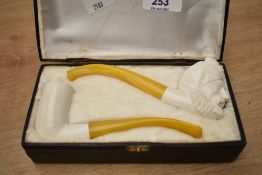 Two vintage meerschaum pipes, one of plain socket form the other carved as an Arabs head, each