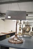 An early 20th century bankers lamp having adjustable neck and raised on a lobed base, h37cm