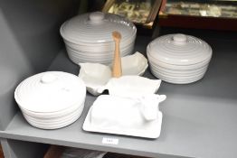 A selection of white kitchenware items including lidded tureens, cow butter dish and hors d'ouvres