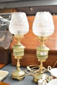 A pair of brass and onyx French style table lamps having floral glass shades, h46cm