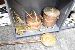 A selection of mixed brass and copper wares, to include a bugle, coal helmet, lidded coal bin,
