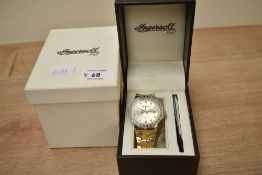 A boxed Ingersoll Gems wristwatch, the golden dial having gemset dot numerals, in a diamond and