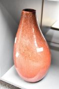 A studio pottery vase having a red glaze ground, h42