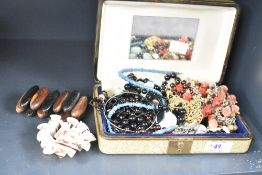 A green faux leather jewellery box, containing a collection of costume jewellery including beaded