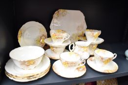 A 1930's Shelley Porcelain teaset, transfer printed and coloured with blossoms, comprising six cups,