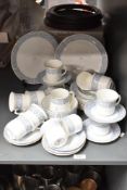 An Atlas Bone China Grimwades part dinner service, decorated with floral patterns on a white ground,