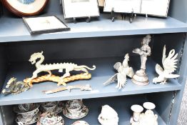 Two eastern cast-brass dragon figures, one larger with carved wooden stand, sold together with a