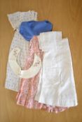 Three vintage baby girl's dresses. A tiered smock with a chambray upper part and and pink floral