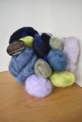 Eleven skeins of mohair wool in a range of colours including sage, lavender, lilac, teal, powder