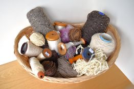A quantity of 20th century wooden bobbins and home spun woollen yarns, in a range of neutral
