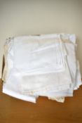 A quantity of home linens, tablecloths and furniture protectors, comprising mostly white cotton