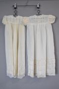 Two 1930s christening gowns, a pale cream silk with puff sleeves and lace panelling, and a creamy