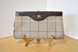 A vintage Burberry cross-body convertible clutch bag in brown leather and plaid cotton canvas,