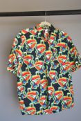 A Guinness cotton short sleeved shirt in multi-coloured toucan print on a black background, size