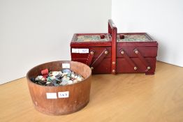 A vintage sewing chest in red wood with tapestry panels, having a lift-up-fold-out construction,