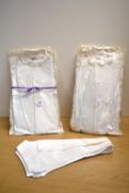 Two 20th century Horne Brothers bib front shorts in off white cotton, with waffle texture starched