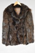 A vintage half length Real Coney fur coat in silky soft brown fur, with wide notch lapels and cool