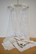 A christening gown featuring highly intricate lace work to include Venetian, Crochet and Broderie