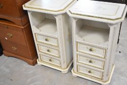 A pair of decorative bedside cabinets having crackled style decoration with foliate detail
