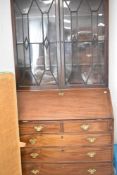 A Georgian and later mahogany bureau having matched astral glazed bookcase over